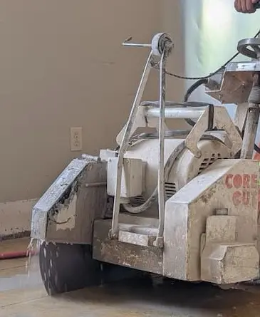 Man with floor sawing equipment